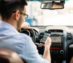 transportation concept - man using phone while driving the car