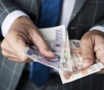 businessman counting czech korunas banknotes