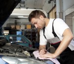 Auto mechanic checking car in service