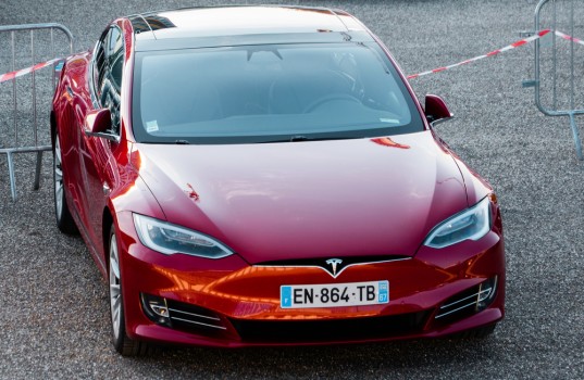 New red Tesla Model S in parking