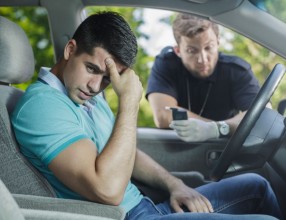 49423463 - worried young driver caught on driving after alcohol