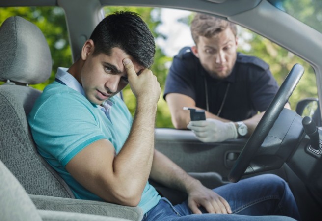 49423463 - worried young driver caught on driving after alcohol