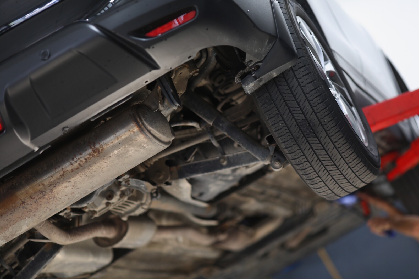 Car,Lifted,In,Maintenance,Service,For,Checkup,,Undercarriage,Of,Automobile,