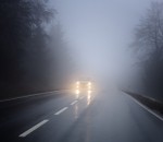Dense fog on the country road, oncoming traffic