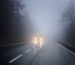 Dense fog on the country road, oncoming traffic