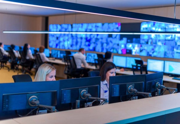 Male computer operator monitoring from a security ( computer, lo