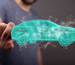 Man's hand pointing at a hologram of an autonomous driving electric car